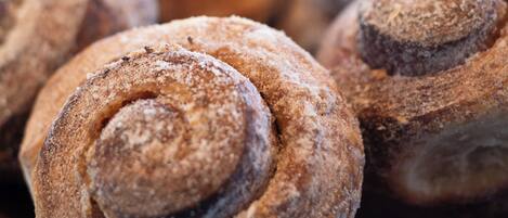 A close-up of cinnamon rolls in a bowl.