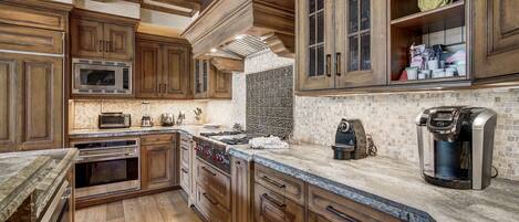 Fridge, dishwasher, coffee/tea maker, cookware/dishes/utensils