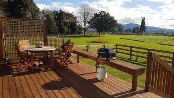 Enjoy al fresco dining on the deck with a grill and scenic views of the surrounding field and mountains.