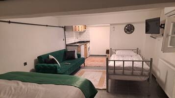 Economy Apartment | Living area | 32-inch Smart TV with satellite channels, TV