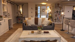 A cozy living room with a sofa, coffee table, and decorative items. - Tropical Garden Oasis  • Birdwatcher's Paradise • Spacious Harlingen Retreat (Harlingen)