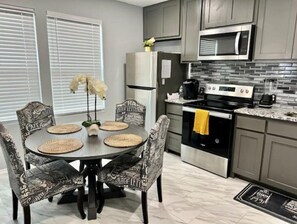 Enjoy cooking in this well-equipped kitchen with a central island, microwave, oven, and coffee maker.