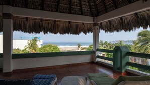 A covered outdoor seating area with a view of the beach and ocean. - Staffed Ocean-View Villa · Private Pool · Starlink · 2 Min to Zicatela (Puerto Escondido)
