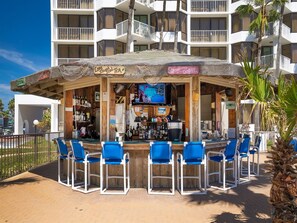 Relax by the ocean at our beachfront bar, where you can enjoy a drink and watch the action on the TV.