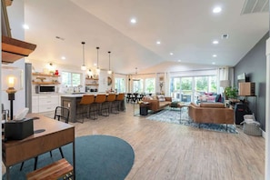 A spacious living area with a kitchen, dining area, and seating space.