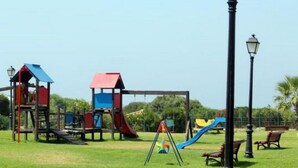 A playground with various play structures including slides and climbing areas. - APCOSTAS - Zahara de los Atunes - Atlanterra (Zahara de los Atunes)