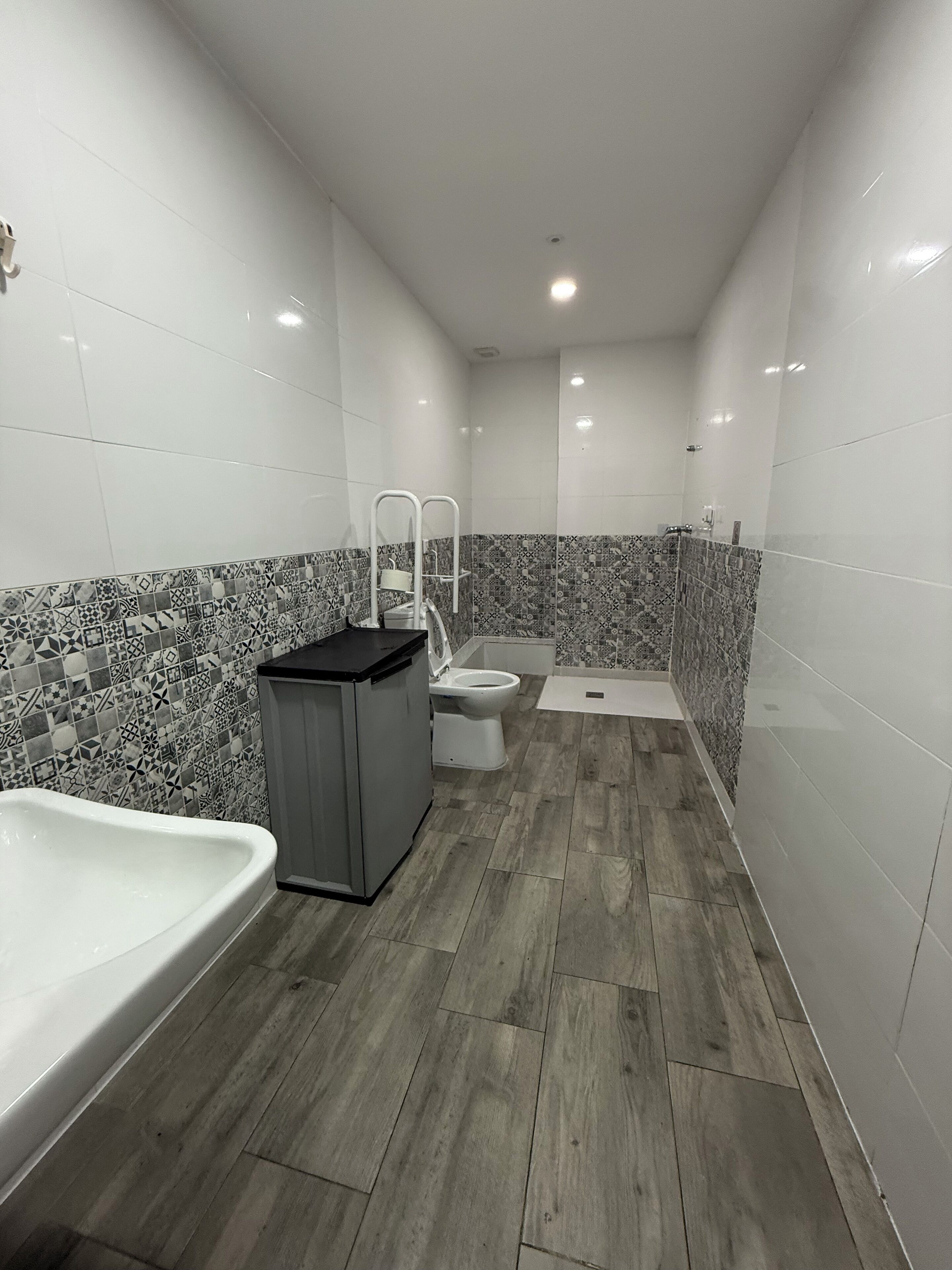 Ein modernes Badezimmer mit Badewanne, Toilette und Duschbereich.