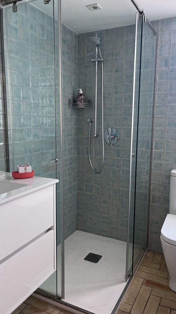 A glass-enclosed shower with a handheld showerhead and a wall-mounted faucet. - A villa that feels like an oasis, with a Mediterranean garden and a heated pool in Cadaqués (Cadaqués)