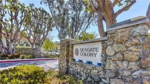A sign for Seagate Colony with a stone wall and greenery around it. - Quiet and cozy condo near Laguna (Aliso Viejo)