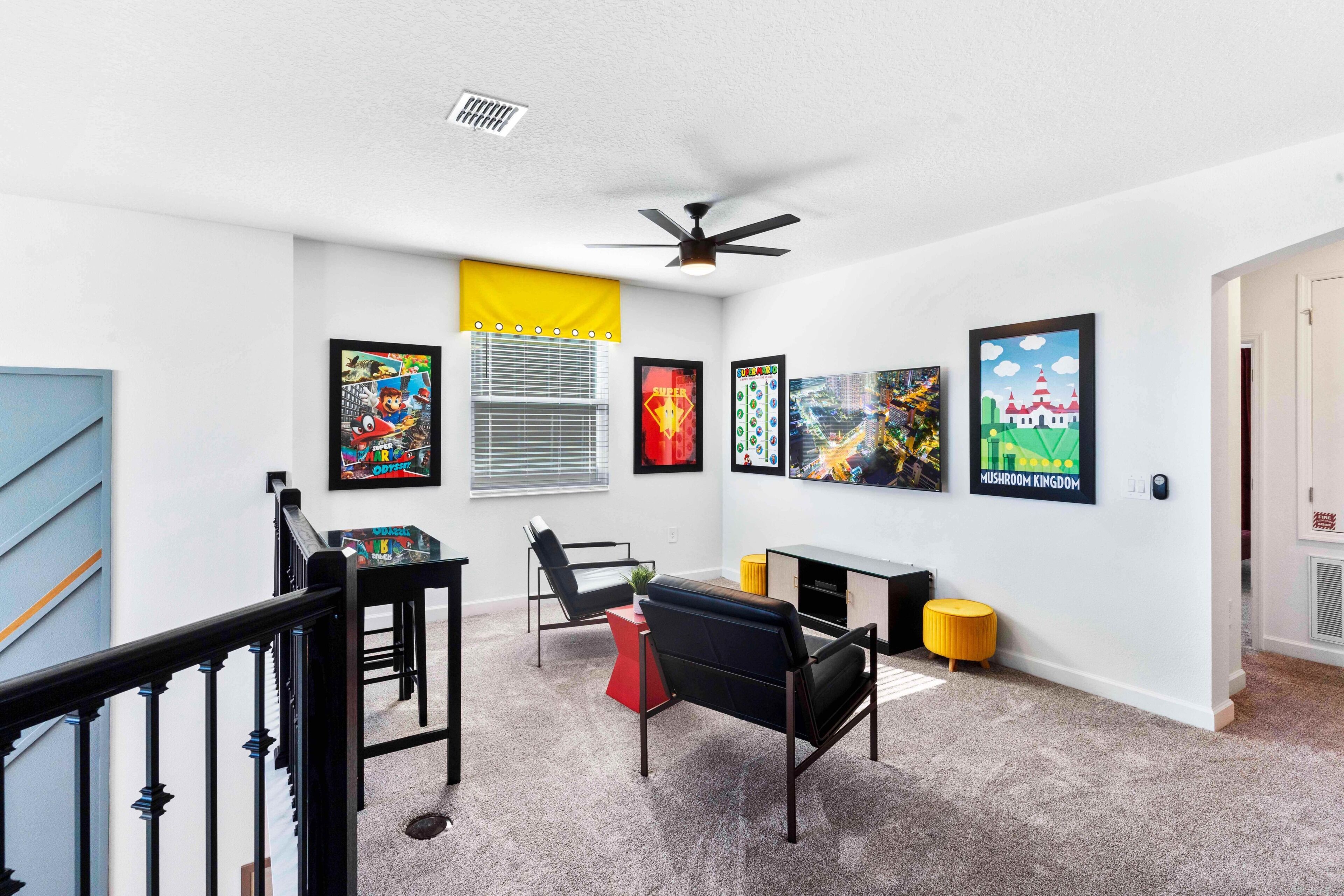 A modern living room with a sofa, chairs, a coffee table, and artwork on the walls.