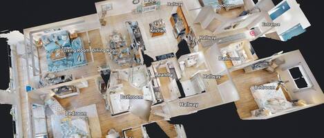 Plano de planta en 3D de un hotel con habitaciones identificadas, incluyendo sala de estar, comedor, cocina, recámaras, baños y un armario.