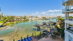A marina with boats docked, a clear sky, and buildings in the background. - Stunning & Spacious Waterfront, French Country Coastal Style, Complex Pool & Hot Tub!   (Clearwater)