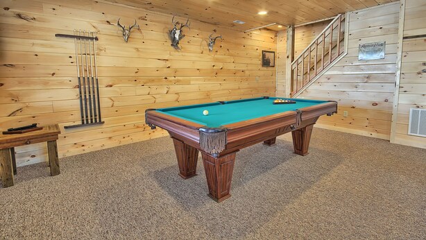 A wooden-paneled room with a pool table, a small table, and a staircase. - Lone Star Lodge - Gorgeous Lodge in Hocking Hills (Logan)