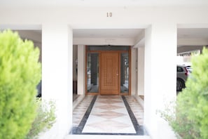 Enter through the central door with a geometric patterned floor.