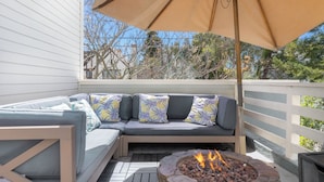 A covered outdoor seating area with a stone fire pit. - Stunning, Beach Home near Santa Cruz Beach & Boardwalk, Walk Downtown! Superhost (Santa Cruz)