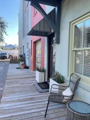 Relax on the deck with two comfortable chairs, surrounded by lush greenery and a beautiful view.