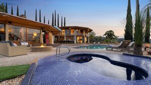 A modern house with a swimming pool, outdoor seating, and tall trees. - Via Vallarta - An Architecturally Significant California Modern Home (Encino)