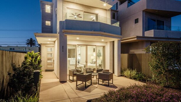 A modern two-story house with a patio, outdoor furniture, and a visible address number. - Large Family Beach Home | 1 Block to Beach & More | AC (San Diego)
