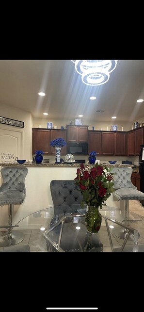 Enjoy cooking in this well-equipped kitchen with a central island and glass table.