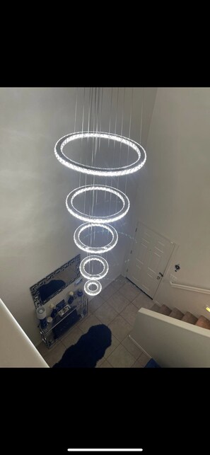 Contemporary interior design features a striking light fixture and neutral-toned walls.
