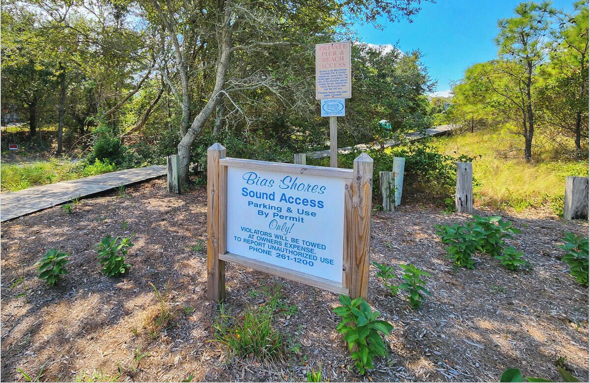 A sign indicating Bias Shores Community Sound Access with a private pier and beach access.