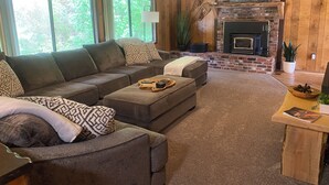 A cozy living room with a fireplace, a sofa, and a coffee table. - Spacious Family Vacation Retreat! (Packwood)