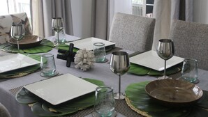 A dining table set with plates, glasses, and a decorative centerpiece. - The View - Heights, Kariba  (kariba)