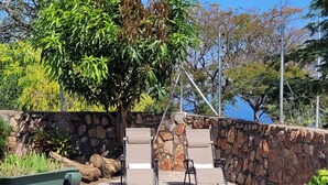 A swimming pool with inflatable toys, lounge chairs, and a stone wall. - The View - Heights, Kariba  (kariba)