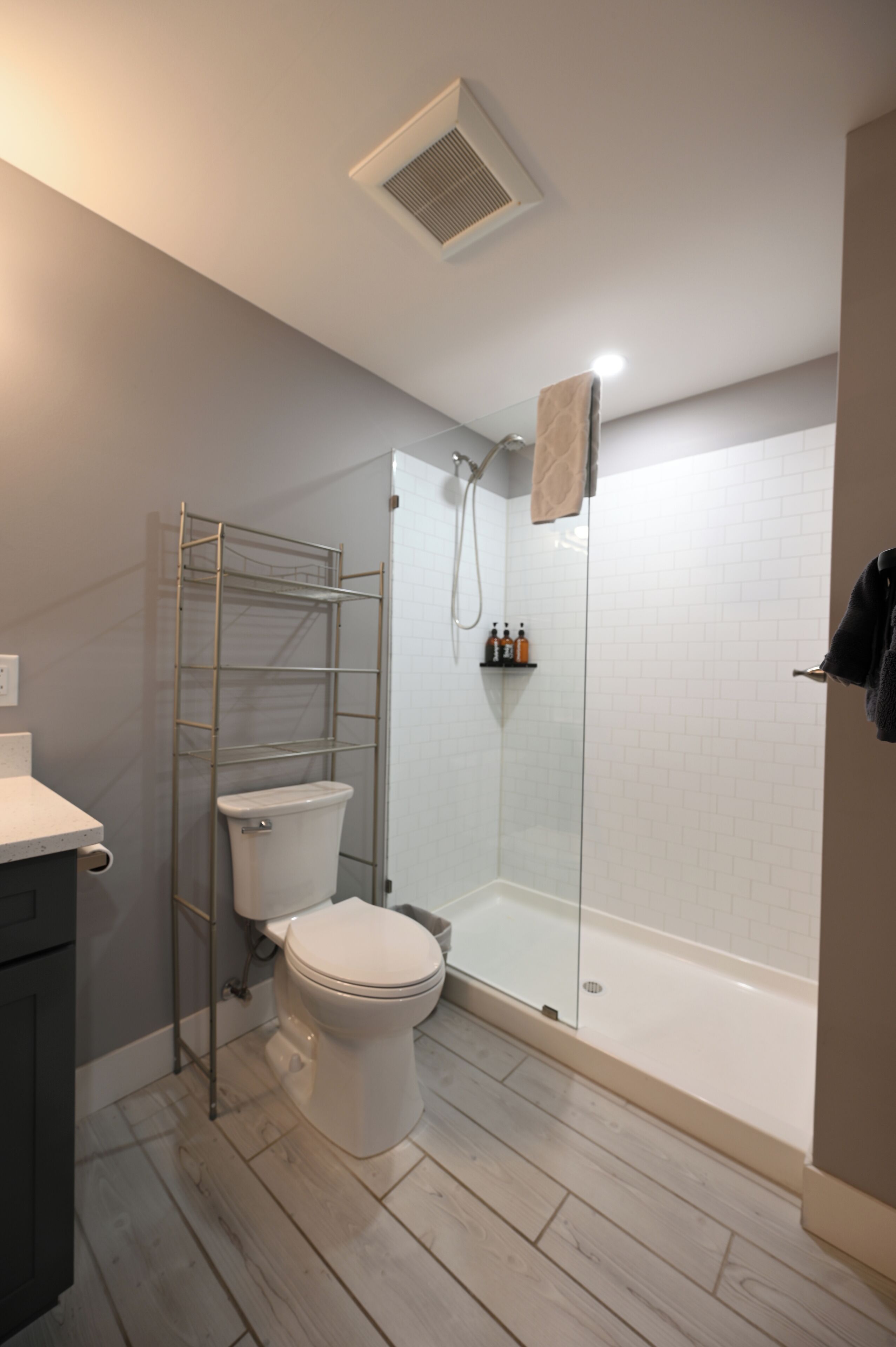 A bathroom with a toilet, a shower, and a bathtub.
