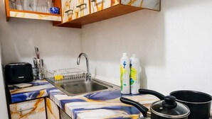A kitchen with marble cabinets, a sink, a stove, and a toaster.
