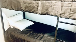A bunk bed with a pillow and a pillowcase. - The Doze Off (Houston)