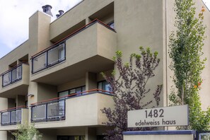 A multi-story building with balconies and a sign indicating '1482 Edelweiss Haus'. - Edelweiss Haus 113 2 Bedroom Condo by RedAwning (Park City)