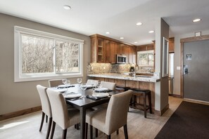A modern kitchen with granite countertops, wooden cabinets, and stainless steel appliances. - Snow Flower 120 2 Bedroom Condo by RedAwning (Park City)