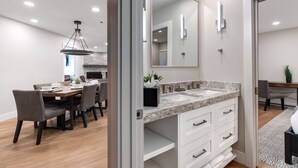 Un baño moderno con un espejo grande, dos lavamanos y un mueble con cajones.