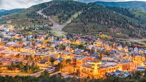 A town with a mix of residential and commercial buildings, a main road, and a hilly backdrop. - Fashion Coalition 402 2 Bedroom Condo by RedAwning (Park City)