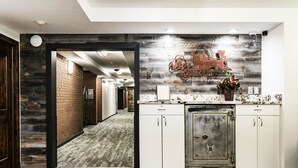 A kitchen with a rustic design, featuring a wooden wall, a vintage refrigerator, and a decorative sign. - Park Station 121 2 Bedroom Condo by RedAwning (Park City)