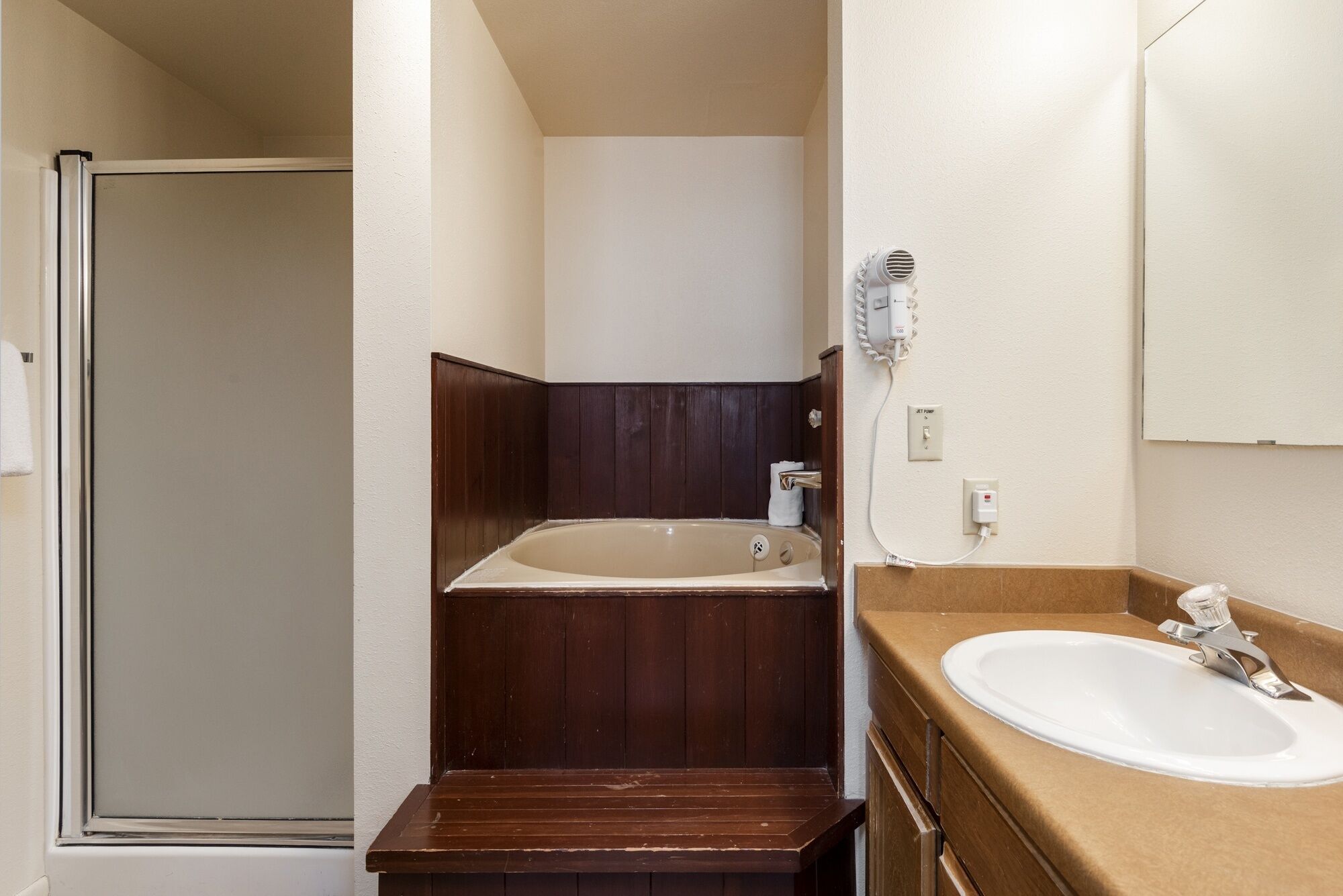 A bathroom with a shower, a bathtub, and a sink.