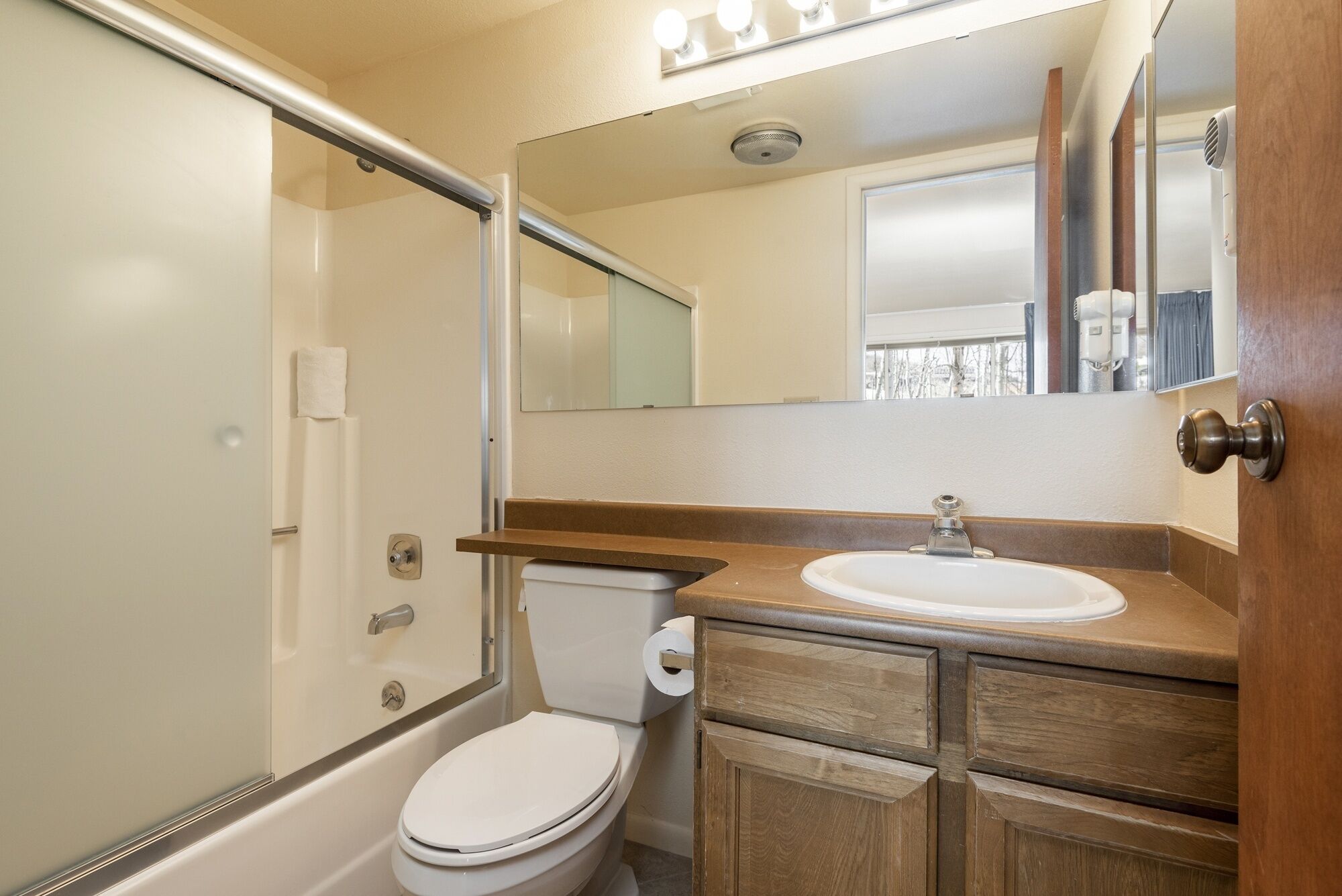 A bathroom with a toilet, a sink, and a shower.