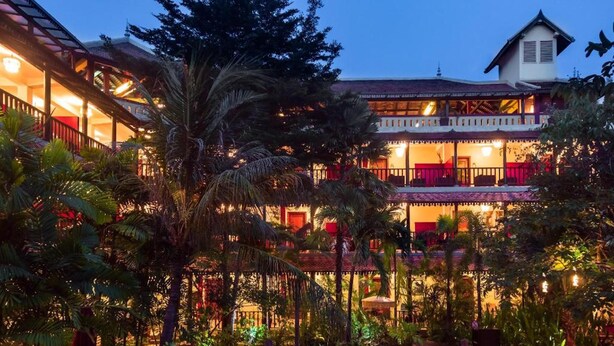 A multi-story hotel with a swimming pool surrounded by lush greenery. - Le Siddharta D'Angkor (Siem Reap)