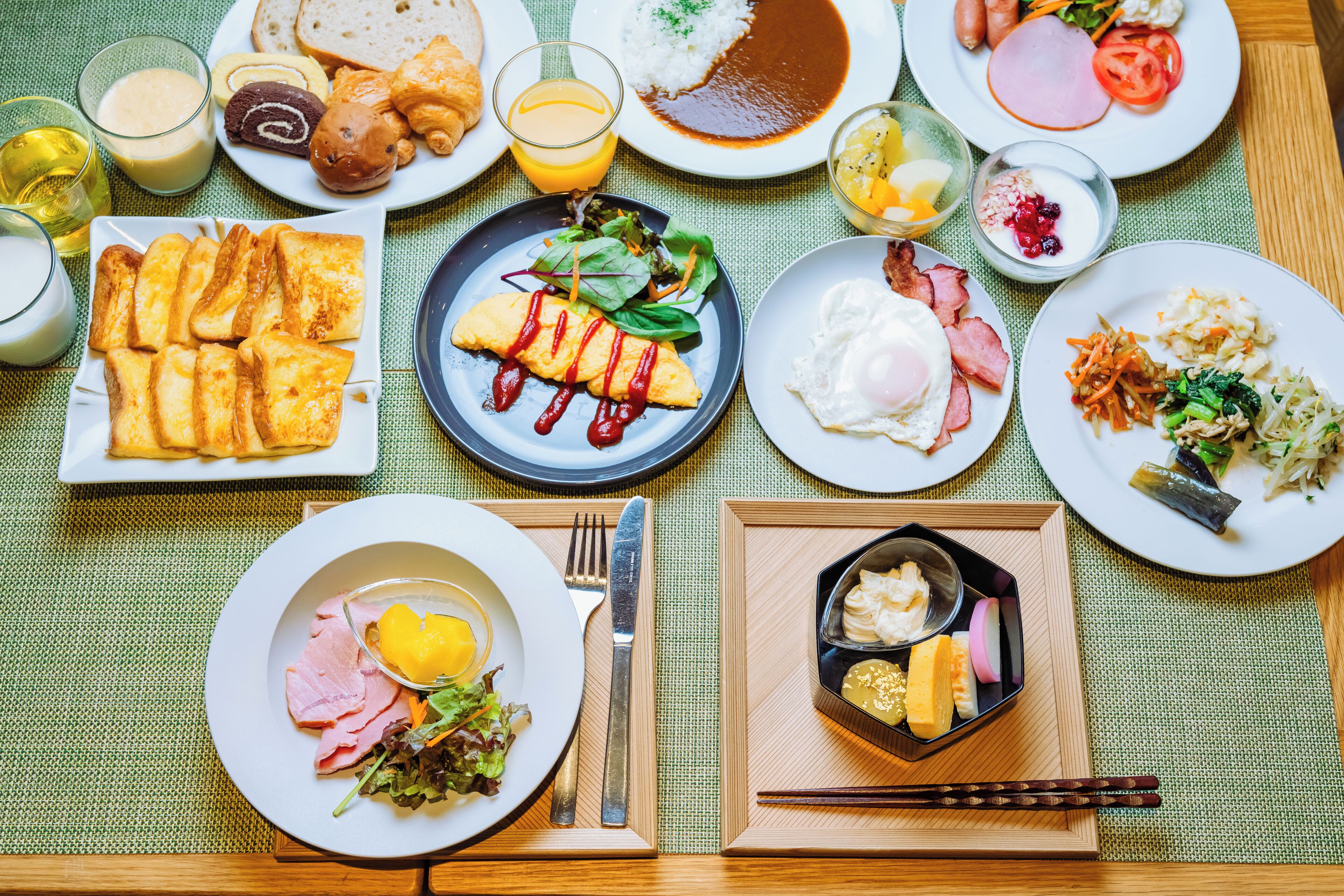 A variety of breakfast dishes on a table with a placemat.