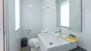 Ein modernes Badezimmer mit Waschbecken, Spiegel und Toilette.