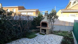A stone-tiled patio with a brick-built outdoor oven. - 2-Room Pavilion with Parking, Near Beach, 6 People (Valras-Plage)