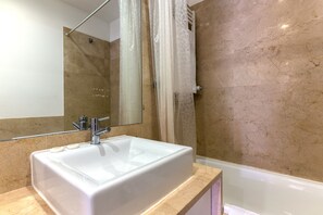 Bathtub, hair dryer, towels, soap