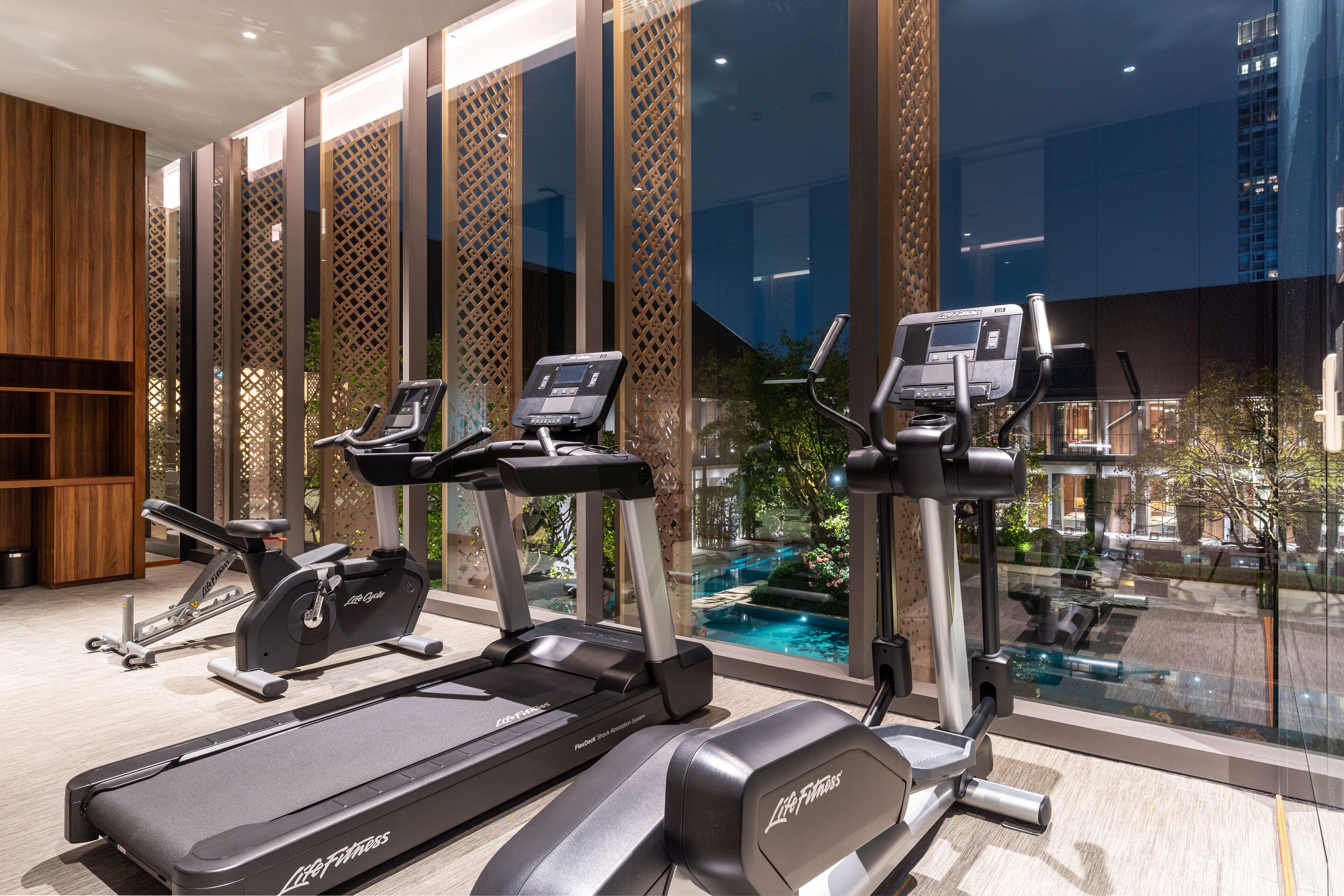 A gym with treadmills, stationary bikes, and elliptical machines.