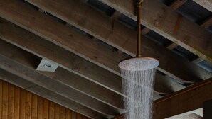 A sauna with a wooden wall and a sign, a water feature, and a pool. - Clifden's premier holiday home with heated pool + sauna - sleeps 24 (Clifden)