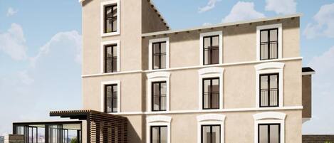 En byggnad med flera våningar, en beige fasad, många fönster och en modern design.
