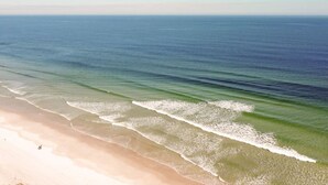 Een strand met helder water en rustige golven.
