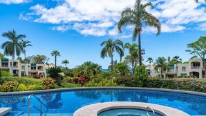A swimming pool with a hot tub, surrounded by palm trees and a landscaped garden. - Tropical Paradise in Luxurious 1br, 2ba Ground Floor Unit, Garden View, Palms 801 (Kihei)