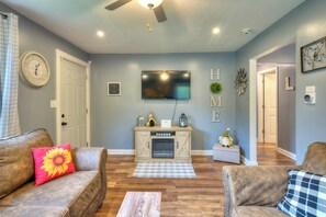 Smart TV, fireplace, books, computer monitors