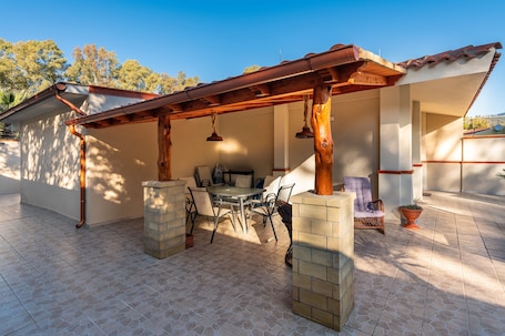 Outdoor dining. Vacation Home "Ibiscus Rosa 1" with Mountain View, Terrace & A/C